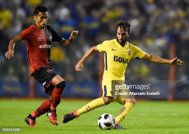 Sebastian Perez of Boca Juniors fights for the ball with Daniel Opazo of Newells Old Boys during a match between Boca Juniors and Newell's Old Boys...