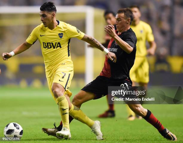 Cristian Pavon of Boca Juniors fights for the ball with Jeronimo Cacciabue of Newells Old Boys during a match between Boca Juniors and Newell's Old...