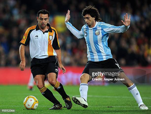 Xavi Hernandez of Catalunya duels for the ball with Javier Pastore of Argentina during the international friendly match between Catalunya and...