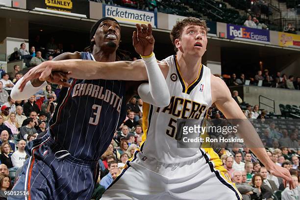 Tyler Hansbrough of the Indiana Pacers boxes out Gerald Wallace of the Charlotte Bobcats during the game on December 16, 2009 at Conseco Fieldhouse...