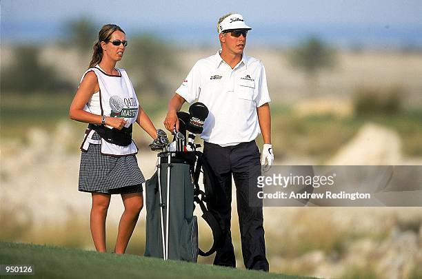 Fredrik Jacobson of Sweden stands with his caddy who is also his sister during the first round of the Qatar Masters 2001 held at the Doha Golf Club,...