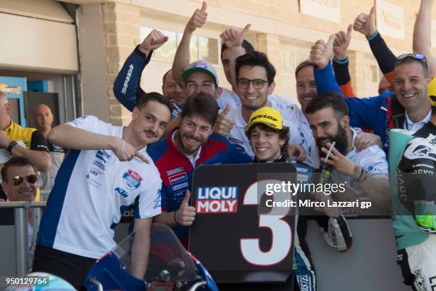 Marco Bezzecchi of Italy and Pruestel GP KTM celebrates the Moto3 third place under the podium with team at the end of the Moto3 race during the...