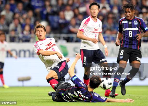 Yoichiro Kakitani of Cerezo Osaka is tackled during the J.League J1 match between Gamba Osaka and Cerezo Osaka at Suita City Football Stadium on...