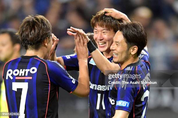 Hwang Ui Jo of Gamba Osaka celebrates scoring the opening goal with his team mates Yasuhito Endo and Jungo Fujimoto during the J.League J1 match...