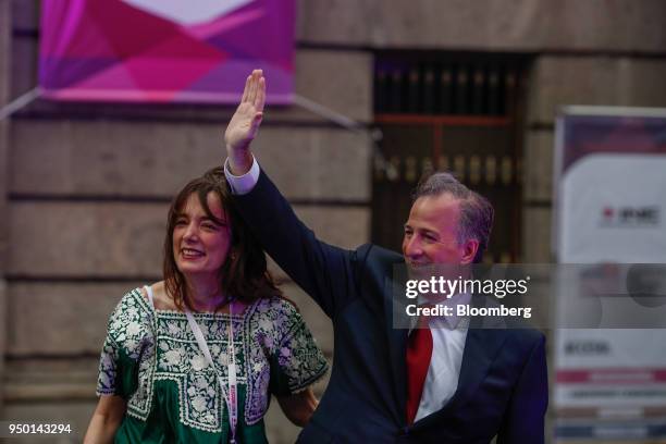 Jose Antonio Meade, presidential candidate of the Institutional Revolutionary Party , right, waves while standing next to his wife Juana Cuevas as...