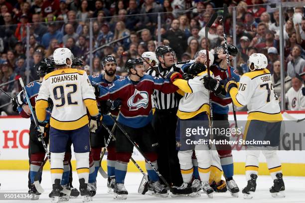 Gabriel Bourque of the Colorado Avalanche fights with Mattias Ekholm of the Nashville Predators in Game Six of the Western Conference First Round...