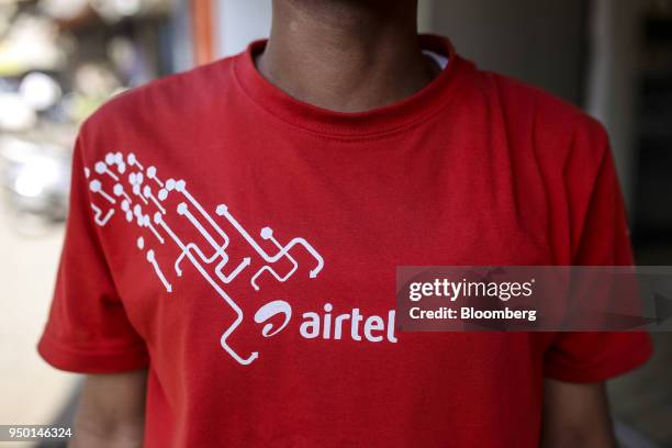 An employee of a Bharti Airtel Ltd. Store poses for photograph in Mumbai, India, on Saturday, April 21, 2018. Bharti Airtel are scheduled to release...