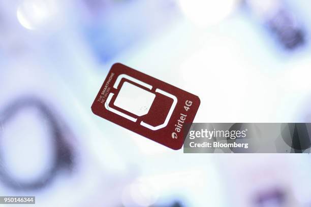 Bharti Airtel Ltd. Sim card holder is arranged for a photograph at a store in Mumbai, India, on Saturday, April 21, 2018. Bharti Airtel are scheduled...
