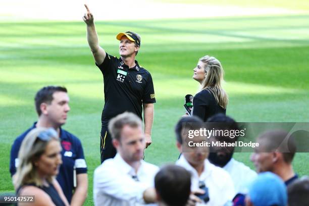Tigers head coach Damien Hardwick gestures to the sky as Demons head coach Simon Goodwin speaks to media during an Melbourne Demons and Richmond...