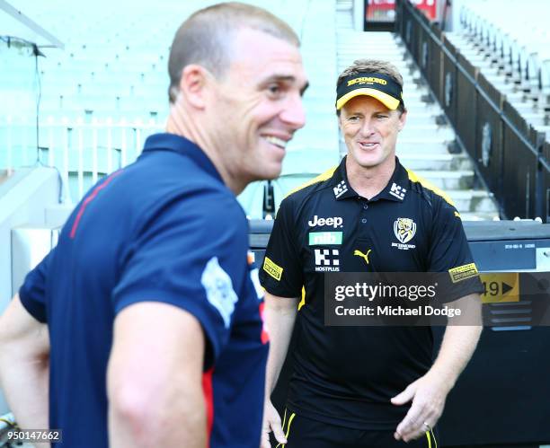 Tigers head coach Damien Hardwick arrives with Demons head coach Simon Goodwin during an Melbourne Demons and Richmond Tigers AFL pre match press...