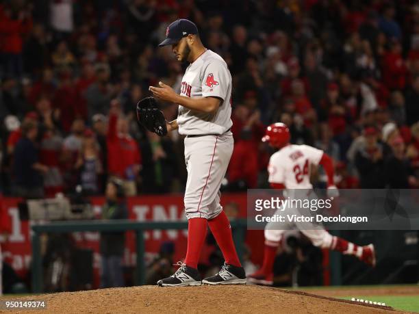 Pitcher Eduardo Rodriguez of the Boston Red Sox looks on after giving up a solo homerun to Chris Young of the Los Angeles Angels of Anaheim in the...