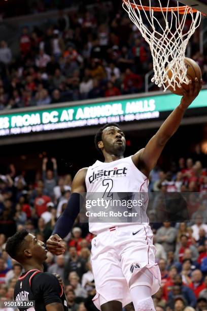 John Wall of the Washington Wizards puts up a shot in front of Delon Wright of the Toronto Raptors in the second half during Game Four of Round One...