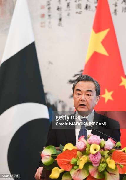 Chinese State Councilor and Foreign Minister Wang Yi speaks during his press conference with Pakistans Foreign Minister Khawaja Muhammad Asif at the...