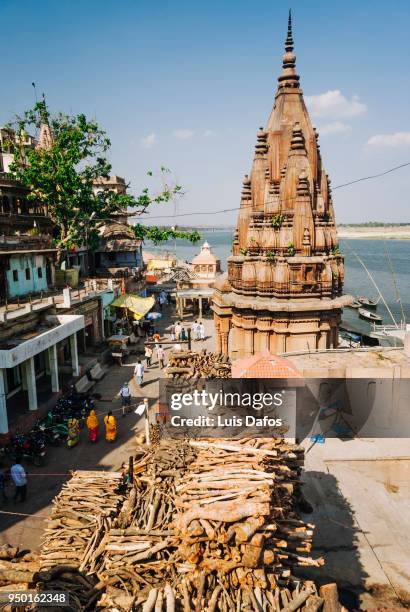 wood piles at manikarnika ghat - manikarnika ghat stock pictures, royalty-free photos & images