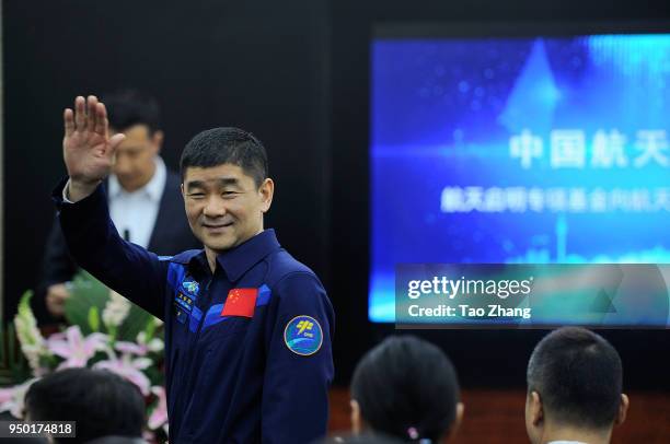 Chinese astronauts Liu Boming waves with students during Chinese astronauts Liu Boming visit to Harbin to celebrate China Space Day at The High...