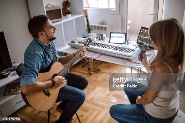 making good music with lots of love - woman in guitar making studio stock pictures, royalty-free photos & images
