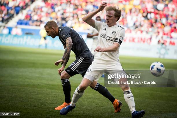 Dax McCarty of Chicago Fire fights for control of the ball against Daniel Royer of New York Red Bulls during the Major League Soccer match between...