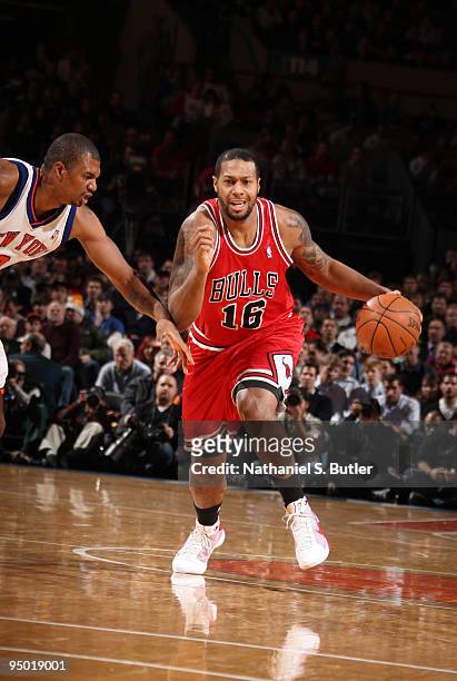 James Johnson of the Chicago Bulls drives against Jonathan Bender of the New York Knicks on December 22, 2009 at Madison Square Garden in New York...