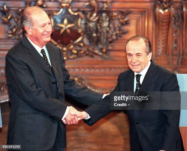 Chilean presidential candidate Ricardo Lagos Escobar shakes hands with senate president and fellow candidate Andres Zaldivar Larrain before their...