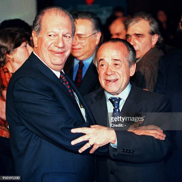 Ricardo Lagos Escobar, a presidential candidate for a coalition of Chilean socialist parties, hugs his opponent, Senator Andres Zaldivar Larrain of...