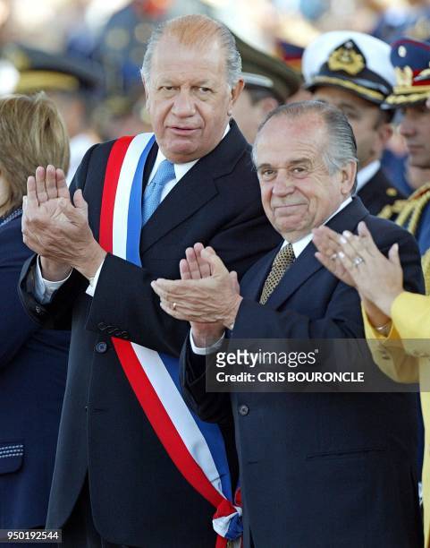 The Chilean President Ricardo Lagos and the president of the senate, Andres Zaldivar, applaud while the troops march during a military parade in...