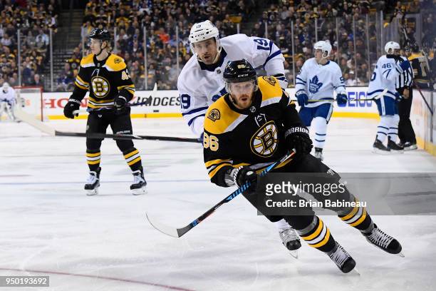 Kevan Miller of the Boston Bruins skates for the puck against the Toronto Maple Leafs during the First Round of the 2018 Stanley Cup Playoffs at the...