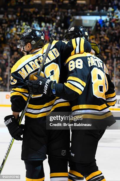 Brad Marchand and David Pastrnak of the Boston Bruins celebrate a goal against the Toronto Maple Leafs during the First Round of the 2018 Stanley Cup...