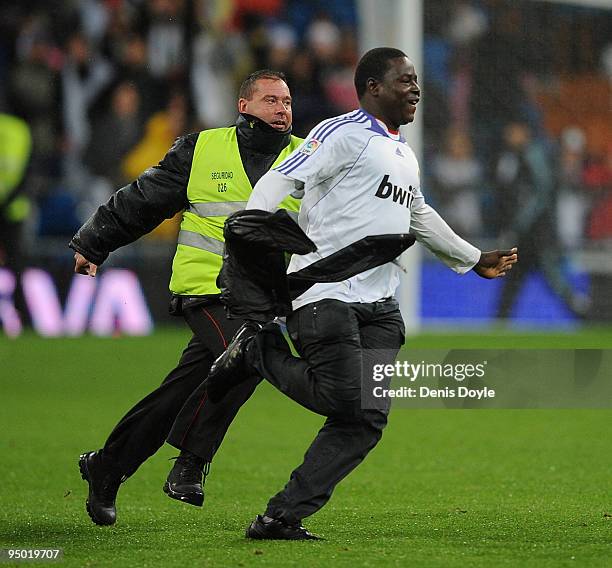 Fan is chased by a security guard afterhe invaded the field at the end of the charity match between Africa United and the La Liga Selection at the...