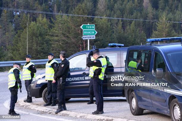 French gendarmes control the entrance to the valley of Nevache on April 23, 2018 near Briancon, southeastern France, a route leading to the Col de...