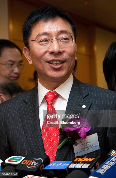 Gao Guofu, chairman of China Pacific Insurance Co., answers questions from the media during the company's stock listing ceremony at Hong Kong...