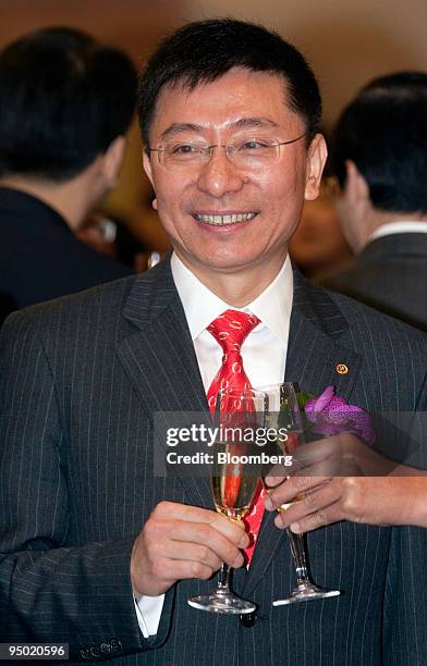 Gao Guofu, chairman of China Pacific Insurance Co., makes a toast during the company's stock listing ceremony at Hong Kong Exchanges & Clearing Ltd....