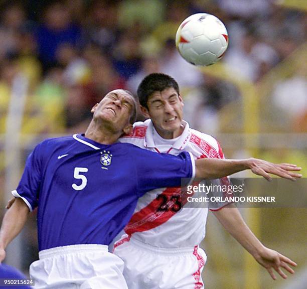 Eduardo Costa of Brazil and Luis Hernandez of Peru fight for the ball, 15 July 2001, in Cali, Colombia, in a Group B game of the Copa America...