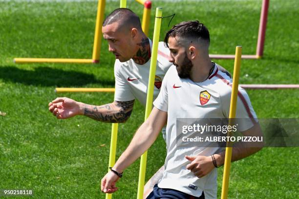 As Roma's players midfielder Radja Nainggolan of Belgium and defender Kostas Manolas of Greece take part in a training session, on the eve of the...