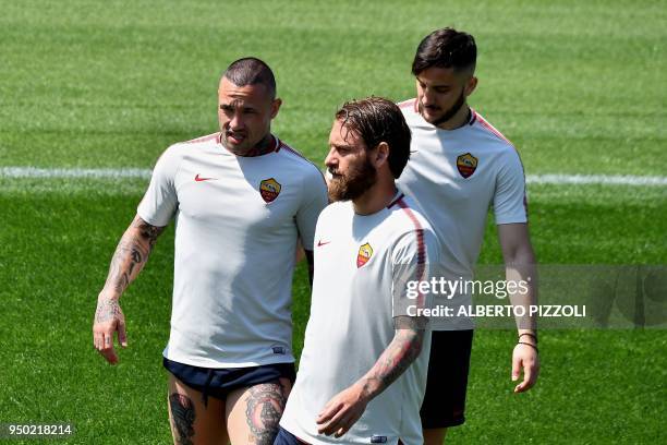 As Roma's players midfielder Radja Nainggolan of Belgium, midfielder Daniele De Rossi , defender Kostas Manolas of Greece take part in a training...