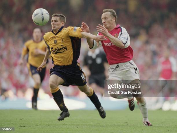 Michael Owen of Liverpool uses his superior pace to beat Lee Dixon of Arsenal during the AXA sponsored FA Cup Final played at the Millennium Stadium,...
