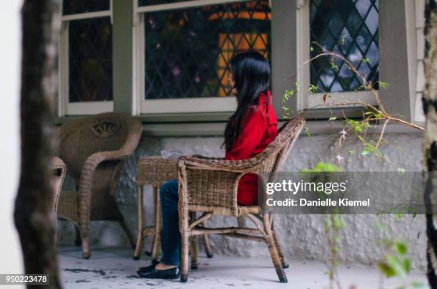 young woman sitting on chair on verandah - katoomba falls stock pictures, royalty-free photos & images