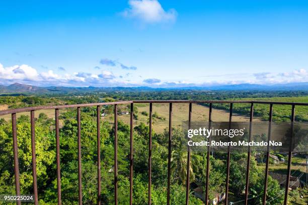 Beautiful Cuban countryside, point of view from the Manaca Iznaga tower. The colonial village of Trinidad is a Unesco World Heritage Site and a major...