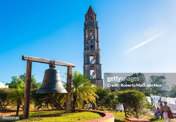 Manaca-Iznaga tower general ambiance, street vendors selling weather appropriate clothing to tourists. The structure is a UNESCO site visited by many.