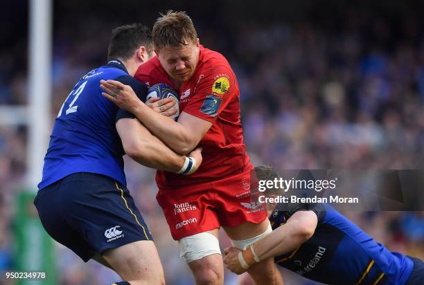 Dublin , Ireland - 21 April 2018; James Davies of Scarlets is tackled by Robbie Henshaw and Garry Ringrose of Leinster during the European Rugby...
