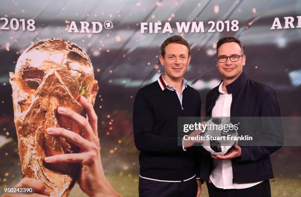 Alexander Bommes and Matthias Opdenhoevel pose for a picture during the ARD and ZDF FIFA World Cup presenter team presentation on April 23, 2018 in...