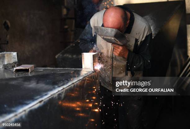 Welder works in the Bab al-Nasr area in old city of Aleppo on April 22 as Syrians start to restore parts of the city. Following a suffocating siege...