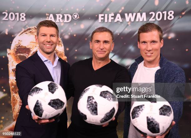 Thomas Hitzlsperger, Stefan Kuntz and Hannes Wolf pose for a picture during the ARD and ZDF FIFA World Cup presenter team presentation on April 23,...