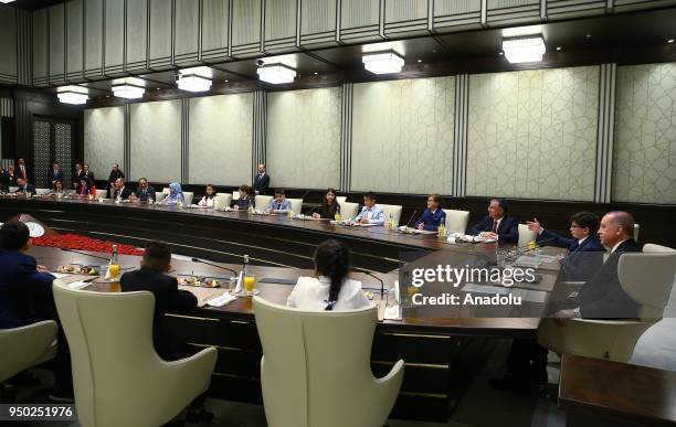 President of Turkey Recep Tayyip Erdogan sits beside Fatih Mintas , a 6th grade student from Cenk Yakin Secondary School sitting on the President's...