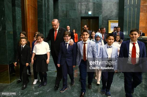 President of Turkey Recep Tayyip Erdogan walks with children during the National Sovereignty and Children's Day at the Presidential Complex in...