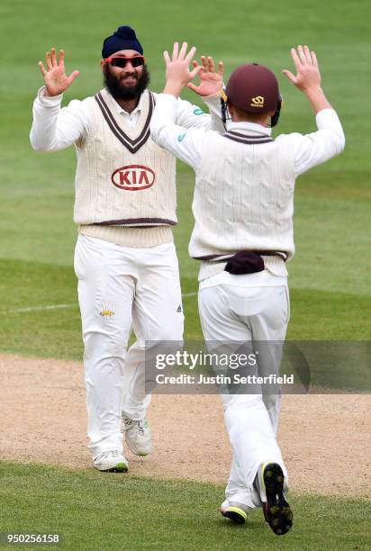 Amar Virdi of Surrey celebrates taking the wicket of Kyle Abbott of Hampshire during the Specsavers County Championship: Division One match between...