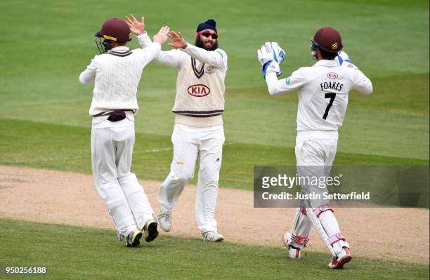 Amar Virdi of Surrey celebrates taking the wicket of Kyle Abbott of Hampshire during the Specsavers County Championship: Division One match between...