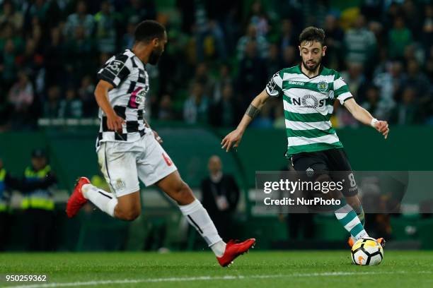 Sporting CP Midfielder Bruno Fernandes from Portugal and Boavista FC Defender Robson from Brazil during the Premier League 2017/18 match between...