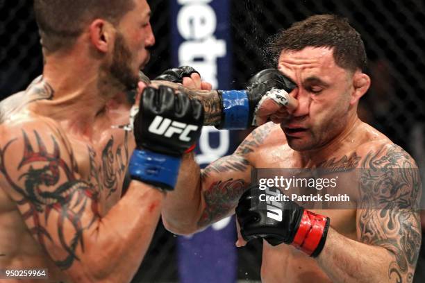 Cub Swanson punches Frankie Edgar in their featherweight fight during the UFC Fight Night event at the Boardwalk Hall on April 21, 2018 in Atlantic...