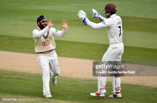 Amar Virdi of Surrey celebrates taking the wicket of Rilee Rossouw of Hampshire during the Specsavers County Championship: Division One match between...