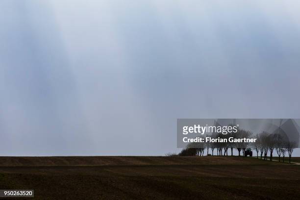 Tractor drives along a track across the fields on April 13, 2018 in Zittau, Deutschland.